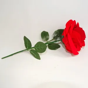 Detailed view of a flocked red rose ring box with green stem and leaves, perfect for proposal.
