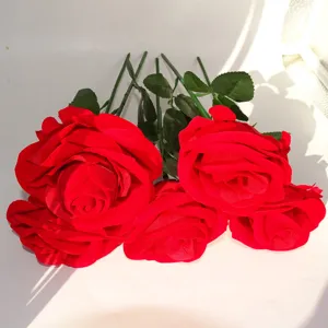 Flocked rose ring box detail, artificial red flower with stem for jewelry presentation, closeup.
