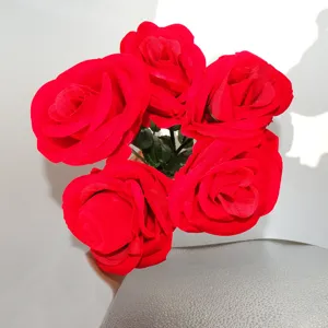 Closeup detail of red velvet artificial rose bouquet ring box, exquisite flower gift ornament.