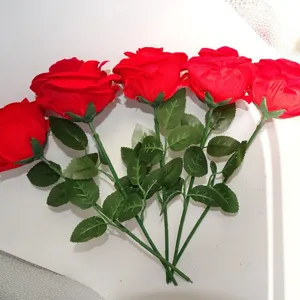 Artificial red roses bouquet with green stems and leaves for romantic gifts and home decor.