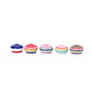 Detail view of colorful striped resin donut beads, perfect for DIY jewelry making and bracelets.