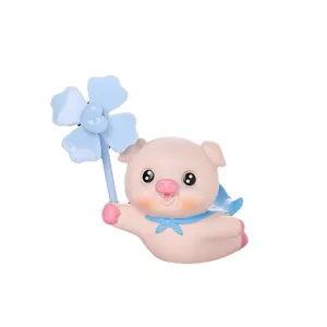Cute flying pig figurine with blue pinwheel and cape, perfect for car vent or desktop decor.