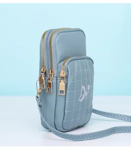 Blue mini crossbody phone bag with multiple zipper compartments and cute butterfly detail.