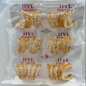 Close-up detail of geometric gold-plated cubic zirconia hoop earrings wholesale packaged.