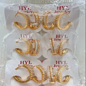 Detail shot of gold-plated pave cubic zirconia hoop earrings neatly packaged on cards.