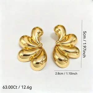 Gros plan détaillé des boucles d'oreilles dorées en forme de pétales de fleurs élégantes.