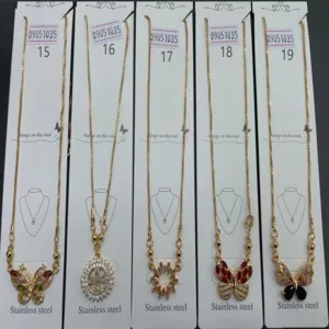Close-up detail view of wholesale stainless steel rhinestone butterfly pendant necklaces display.