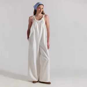 White loose casual jumpsuit detail, comfortable suspender wide leg pant view for women styling.