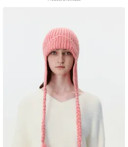 Pink knitted earflap hat with long braided straps, stylish winter warm windproof cap.