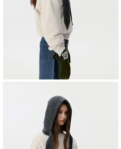 Knitted hooded scarf detail shot, cozy winter warm bib hat, soft textured grey fabric style.