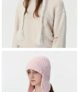 Cozy winter warm knitted ushanka hat and stylish distressed pullover sweatshirt set for women.
