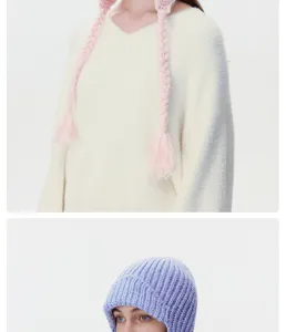Detailed close-up view of winter cozy knitted braided ear-flap hat and ribbed beanie.
