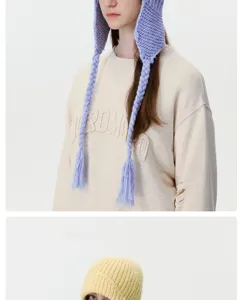 Winter warm knitted ear-flap hat with braided tassels for women, cozy pilot wool beanie cap.