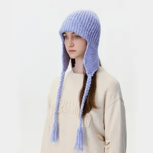 Winter warm knit earflap hat for women with braided tassels, stylish windproof fleece beanie.