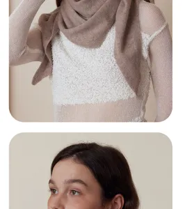 Close-up detail of a soft knit triangular scarf worn by a model for autumn winter style.