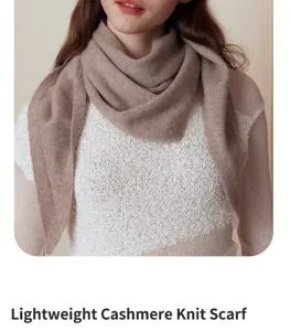 Close up view of soft knit triangular scarf in brown, cozy autumn winter neck accessory.