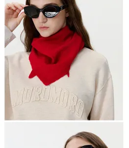 Red cashmere wool knitted triangular scarf detail, warm winter neck warmer piece.