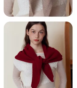 Close-up detail of the wine red knitted triangular scarf, soft warm autumn winter wear.