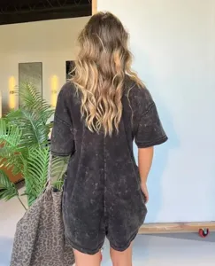 Distressed knit short romper jumpsuit detail shot, casual oversized design for women.