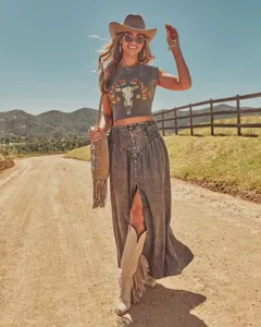 Bohemian vintage washed denim maxi skirt with high smocked waist and front slit detail.