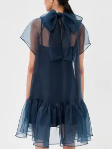 Navy blue sheer chiffon mini dress featuring an elegant back bow and playful ruffled hem.