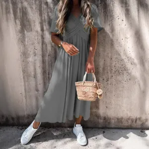 Women solid color short sleeve crossover v-neck casual midi dress main product lifestyle view.