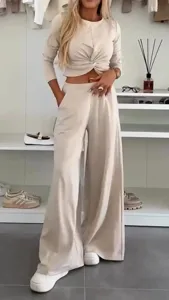 Detail view of the elegant beige two-piece casual set displayed in a modern dressing room.