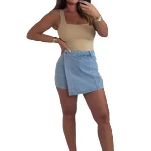 Women's asymmetric light blue denim mini skirt paired with a stylish fitted top outfit