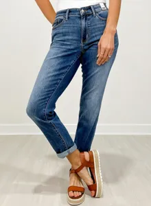Detailed view of women's mid-rise denim jeans featuring classic washed finish and slim fit.