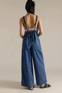 Back view of casual blue denim jumpsuit with tie strap and wide legs, comfortable fit.