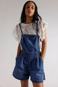 Detailed view of women's denim overalls shorts featuring classic blue wash and relaxed fit.