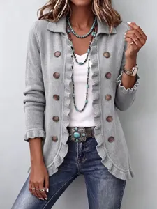 Close-up detail of women's grey knit cardigan with ruffle trim, double-breasted buttons.