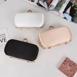 Elegant evening clutch bag featuring a dazzling rhinestone ring clasp and smooth satin finish.