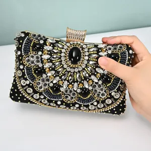 Close-up of luxury beaded evening clutch bag with sparkling crystals and intricate embroidery.