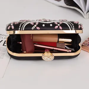 Black satin evening clutch with rhinestones pink crystals and gold ring clasp for party.