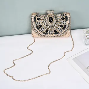 Detailed view of luxury beaded evening clutch bag with sparkling crystals and chain strap.