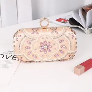 Elegant champagne satin evening clutch bag with pink crystals pearls and ring clasp for women.