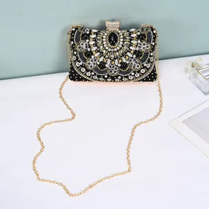 Elegant black beaded evening clutch bag with rhinestones and gold chain for women luxury party.