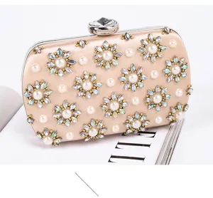 View of champagne satin evening clutch featuring sparkling pearl and crystal flower motifs.
