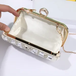 Elegant white rhinestone evening clutch bag with metal frame, ring clasp and chain strap.
