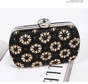 Black satin crystal evening clutch bag with rhinestone floral design for women party.