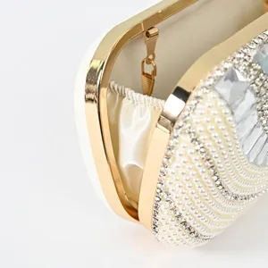 Elegant pearl embellished evening clutch bag with gold metallic frame and crystal details.