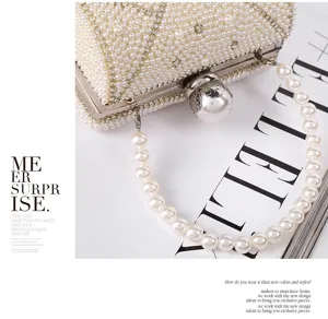 Detailed close-up of luxurious pearl evening clutch bag with elegant handle and frame.