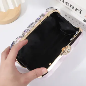 Stunning rhinestone evening clutch bag with colorful crystals and gold metal frame for parties.