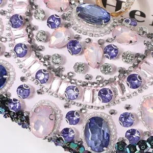 Close-up of handmade crystal beaded evening bag with sparkling colorful rhinestones and satin base.