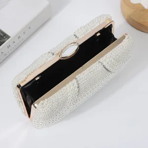Elegant pearl evening clutch bag with gold metal frame and crystal clasp for women parties.