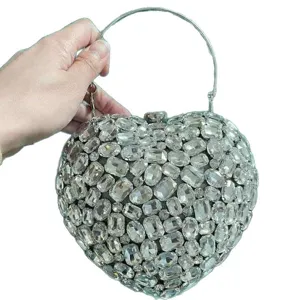 Detailed view of the sparkling heart-shaped rhinestone evening bag with crystal stone inlay.