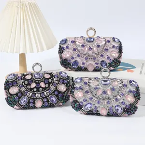 Detailed view of luxury rhinestone beaded evening clutch bags with sparkling crystals and metal rings.