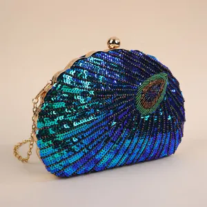 Detailed view of exquisite peacock sequin evening clutch, handmade bead embroidery and gold chain.