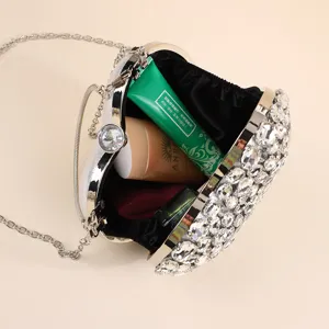 Sparkling rhinestone heart-shaped evening clutch bag detail view, showing elegant interior.